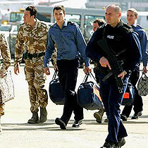 Wearing military uniforms and carrying gifts from the Iranian regime, 15 Royal Navy marines and sailors arrived at London's Heathrow Airport Thursday after being held by Iran for nearly two weeks.