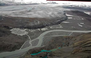 A glacier is poised to dam the only river that cuts through a rugged 500-mile span of the St. Elias Mountains.